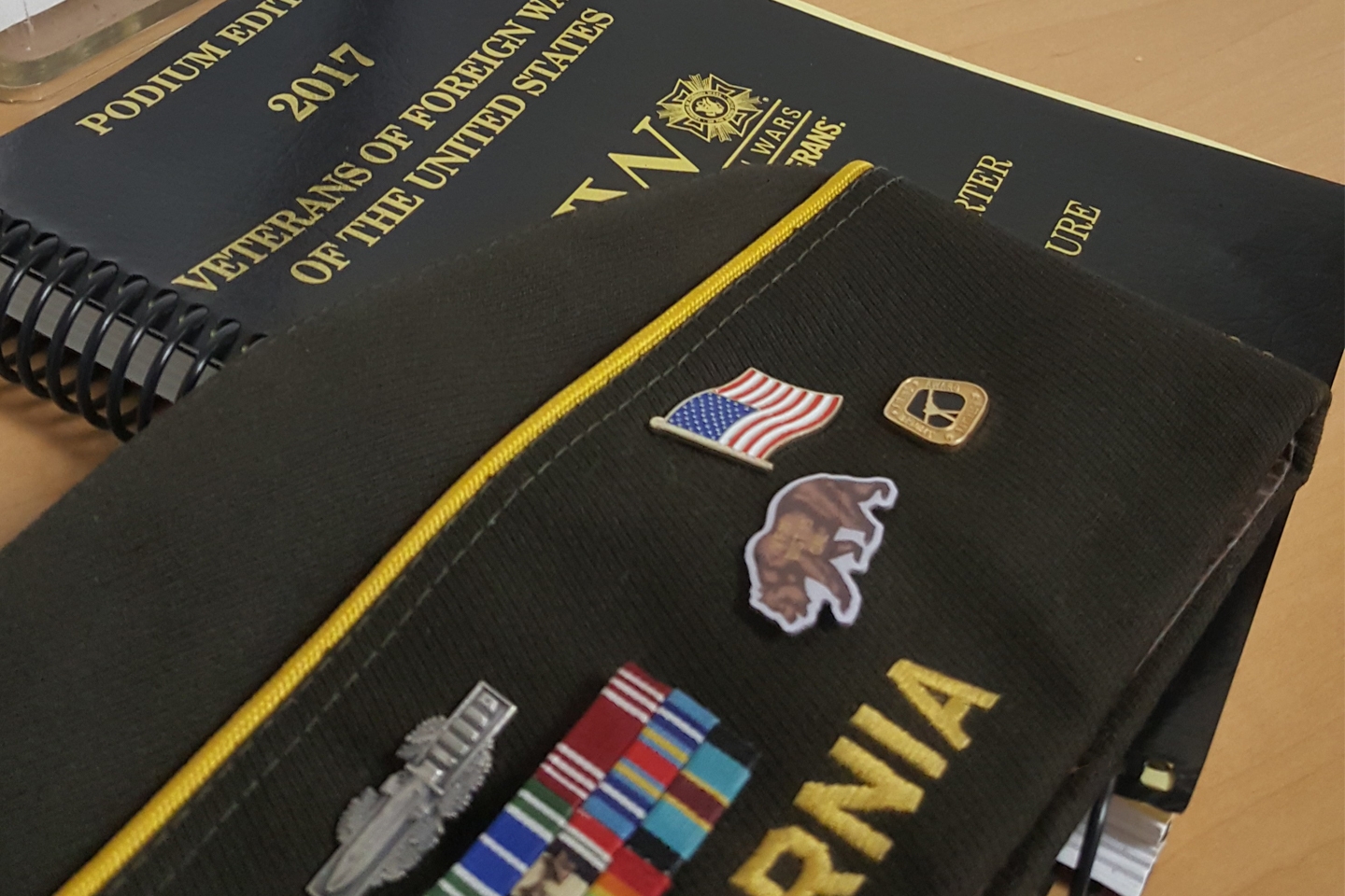 A VFW members cap and the 2017 VFW Manual of Procedure.